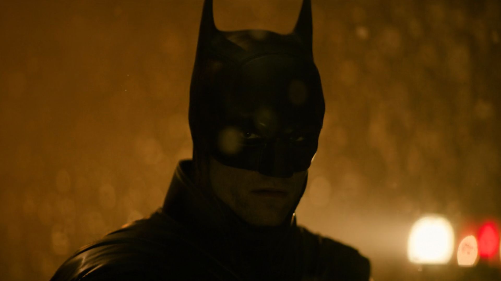 an image from the teaser clip of Batman Part II showing Robert Pattinson as Bruce Wayne / Batman against a snowy, siren-lit night in Gotham