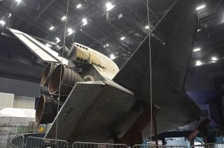 Space shuttle Atlantis is seen from behind and below, its protective shrink-wrap cover removed, at NASA's Kennedy Space Center Visitor Complex in Florida, April 26, 2013.