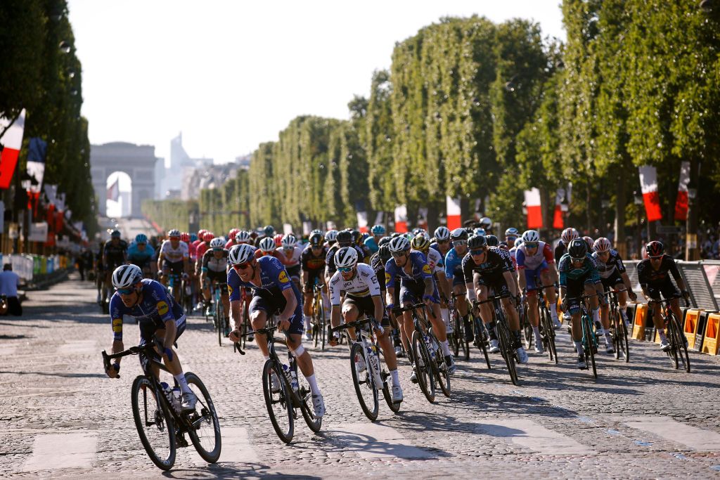 PARIS FRANCE JULY 18 Dries Devenyns of Belgium Michael Mrkv of Denmark Julian Alaphilippe of France and Team Deceuninck QuickStep lead The Peloton passing through The Champslyses during the 108th Tour de France 2021 Stage 21 a 1084km stage from Chatou to Paris Champslyses Arc De Triomphe LeTour TDF2021 on July 18 2021 in Paris France Photo by Chris GraythenGetty Images