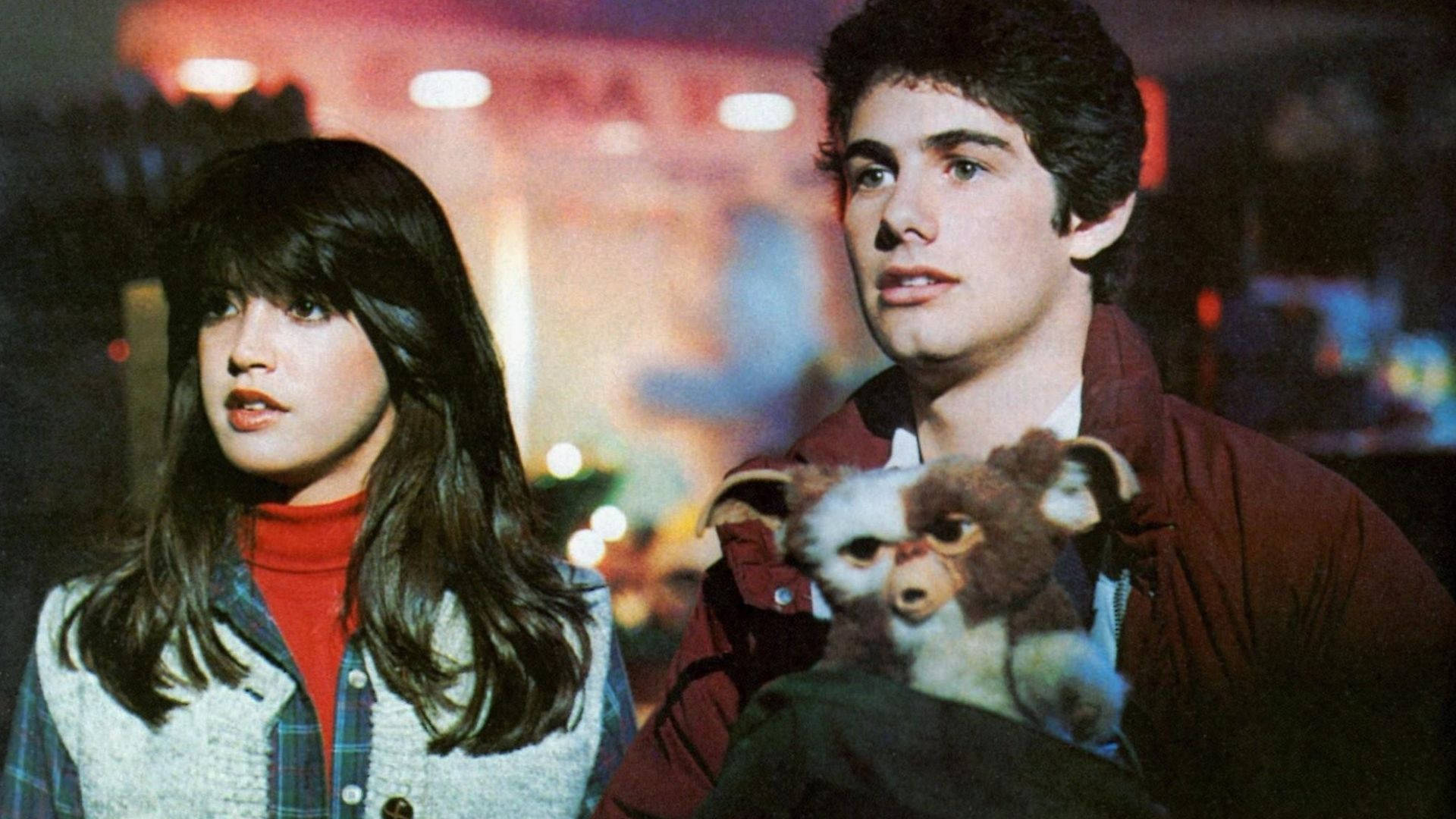 A still from the movie Gremlins starring Zach Galligan as Billy Peltzer and Phoebe Cates as Kate Beringer.