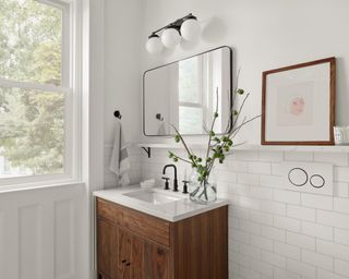 White bathroom with wooden vanity and mirror