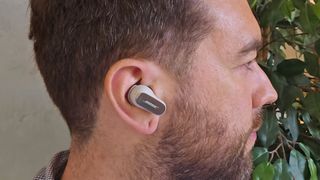A person wearing the Bose QuietComfort Ultra earbuds