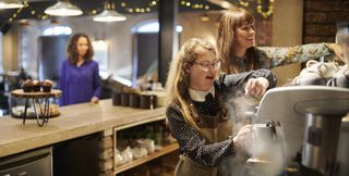 teenage girl working in a coffee shop as a barista