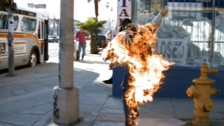 Man running down the street on fire in music video for Wax's California on Beavis and Butt-Head