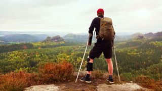Man Hiker Wearing Supportive Leg Brace And Gainst The Cruthes