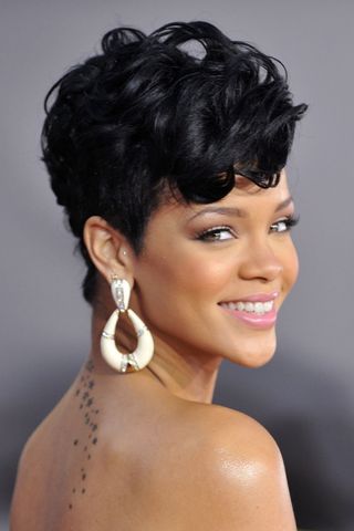 Rihanna has a pixie cut that is longer on top, as she arrives at the 2008 American Music Awards held at Nokia Theatre L.A. LIVE on November 23, 2008 in Los Angeles, California.