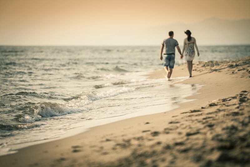 Romantic couple walking on the beach.