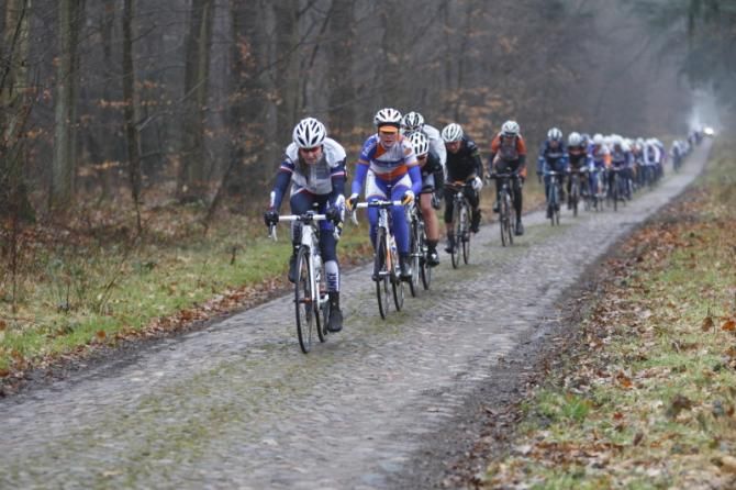A long line of riders on the second section of cobbles