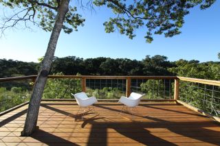 A tropical deck with a tree in the middle