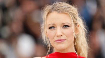 blake lively wearing red on a muted background