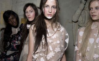 four female models facing in different directions wearing clothes by simone rocha
