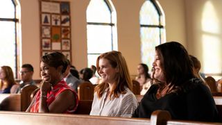 The three friends sit next to each other in church in Sweet Magnolias