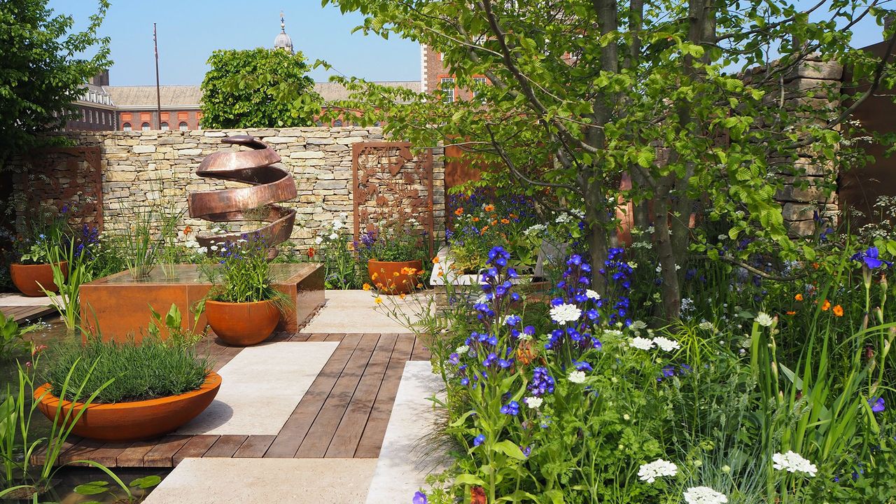 garden area with copper garden sculpture and plants and pots