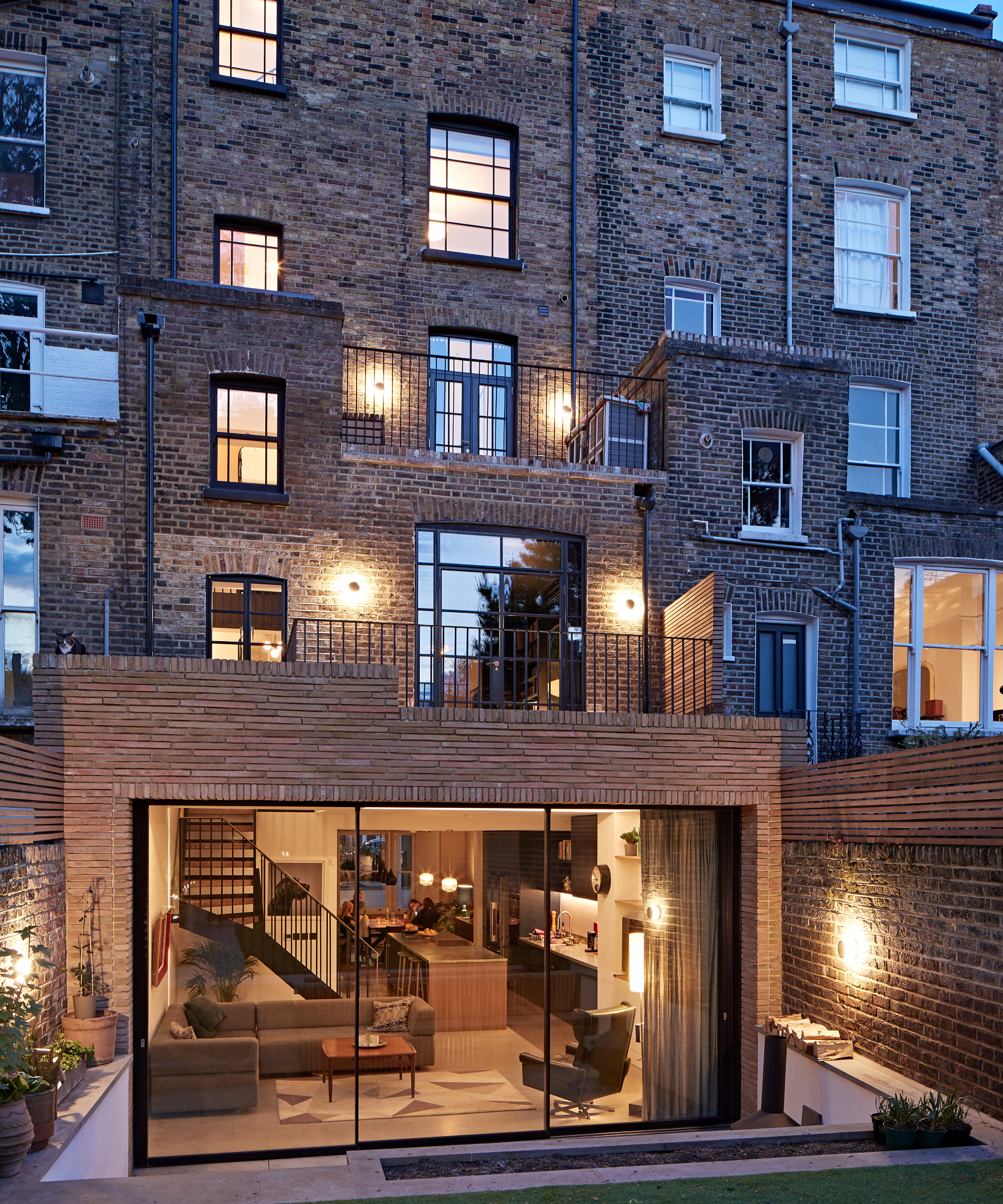 victorian town house in brick with rear double storey extension, large sliding patio doors to ground floor level leading to garden