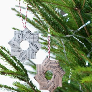 Christmas decorations make from sheet music hanging from tree