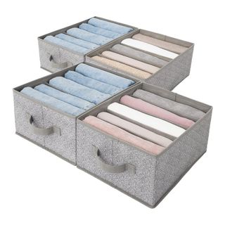 A cut out image of four drawer organisers with folded clothes in them