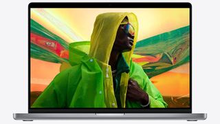 Best student MacBook, a photo of a MacBook displaying image of man posing in fashionable clothes and sunglasses