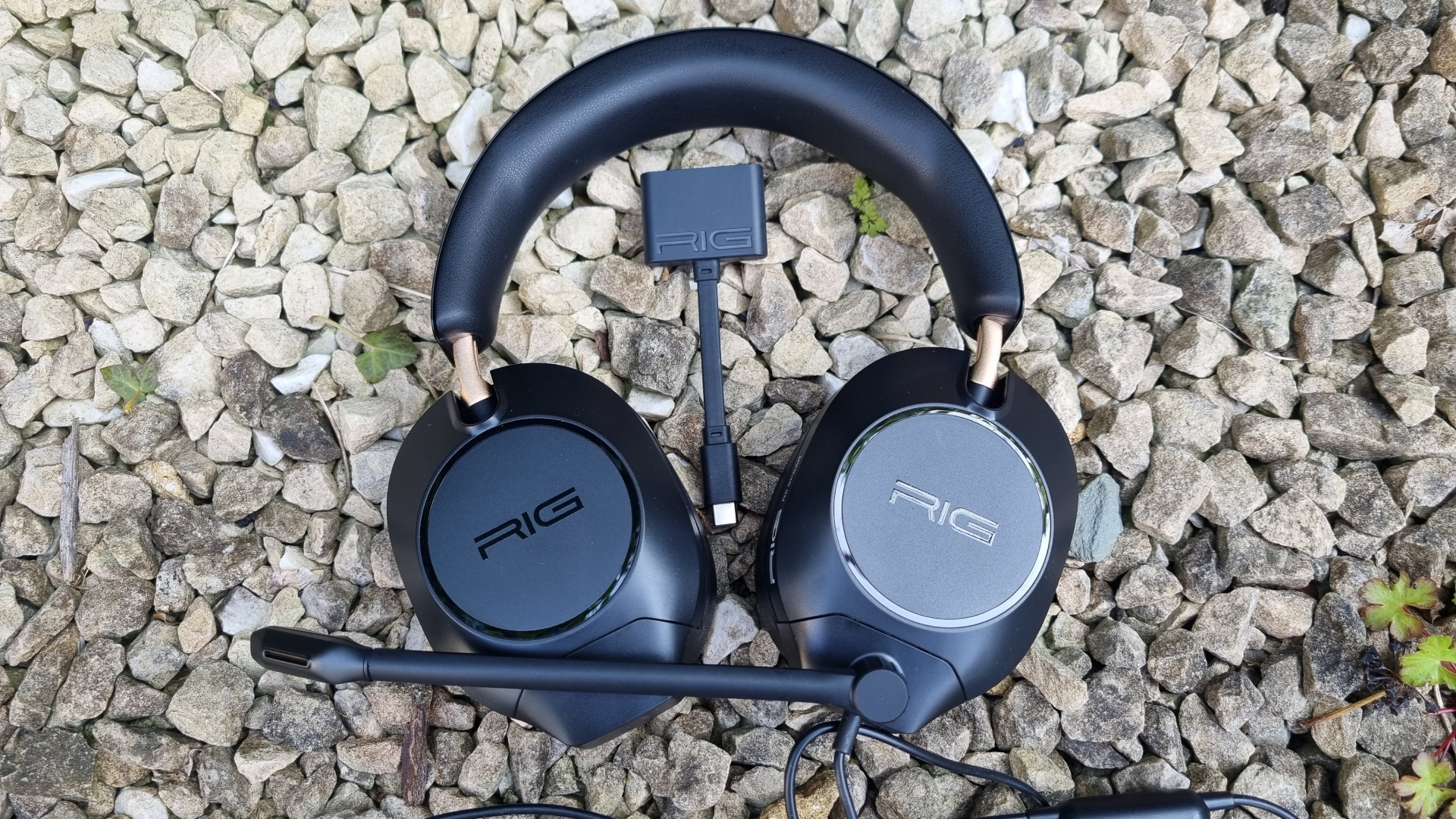 A Rig R5 Spear Max HD gaming headset on top of some gravel