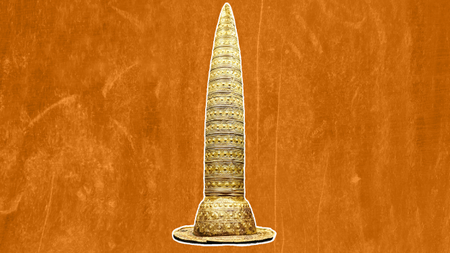 a pointy gold hat against an orange background
