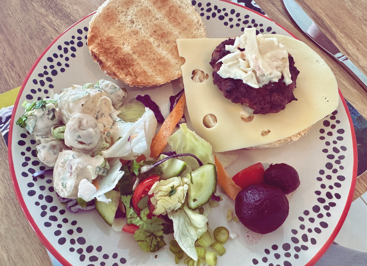 A plate of food including a home-made burger cooked on the Weber Master-Touch GBS C-5750 Charcoal Barbecue