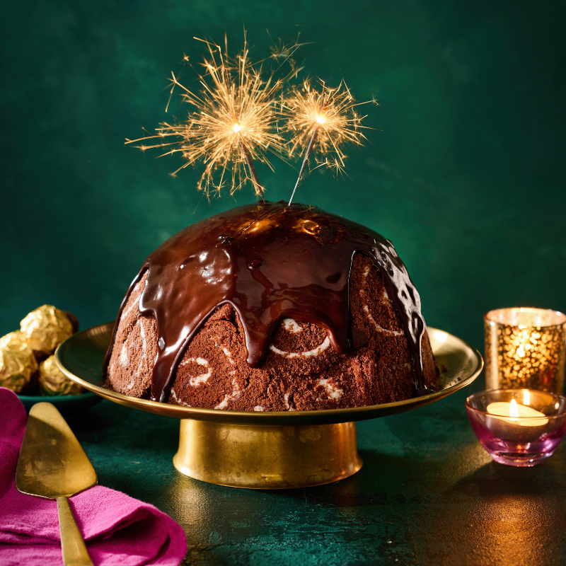 Woman&home's Chocolate, hazelnut and Irish cream liqueur bombe served on a cake plate with a sparkler on top