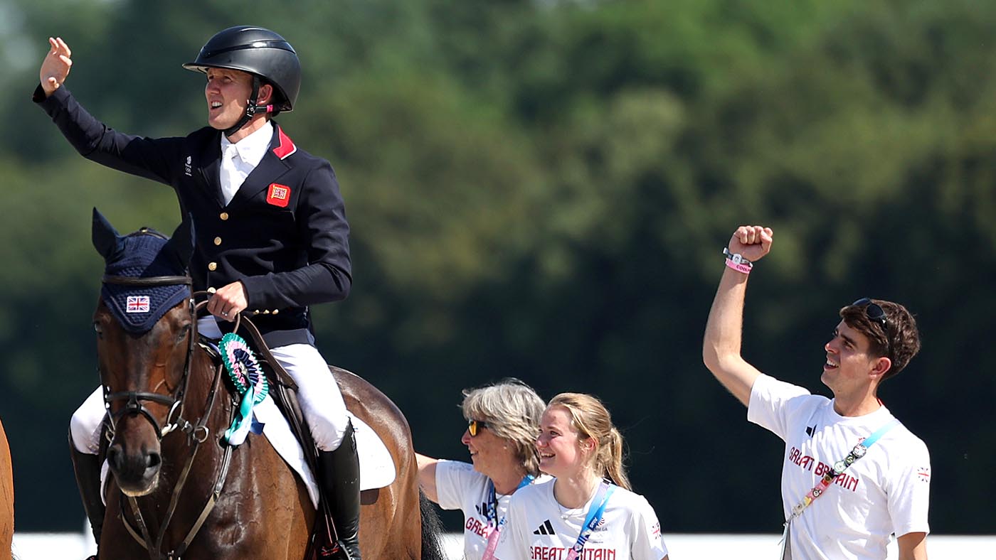 Groom Adam Short cheers during the medal ceremony at the Paris Olympics.