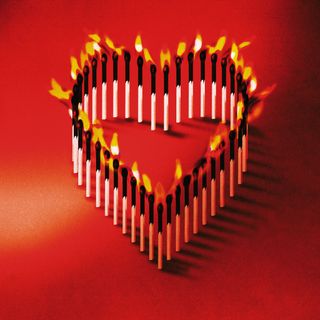 Lit matches shaped into a heart