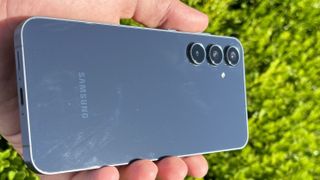 Samsung Galaxy A55 showcasing fingerprint smudges on its rear glass