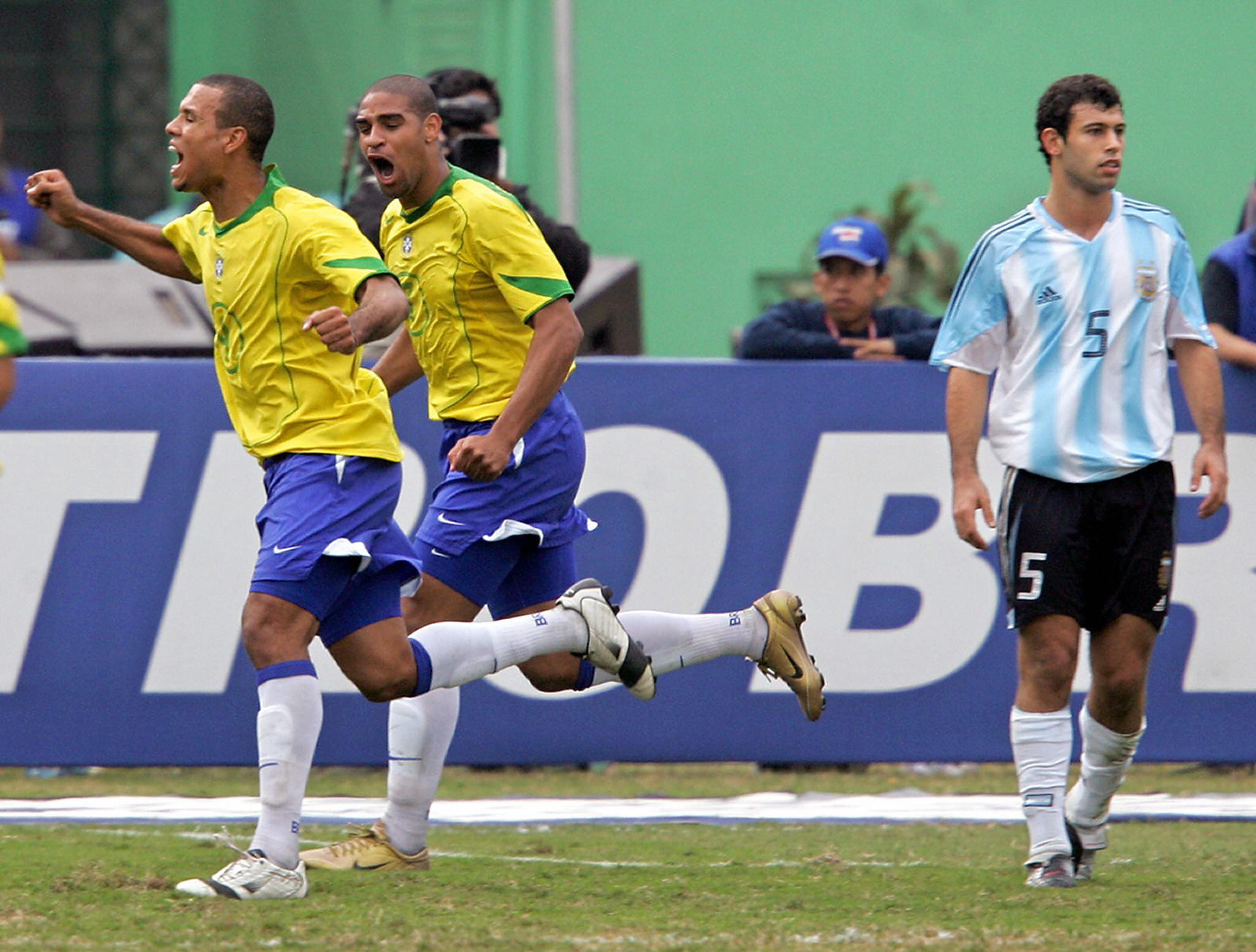 Luis Fabiano and Adriano celebrate a goal for Brazil against Argentina in the 2004 Copa America final as Javier Mascherano looks dejected.