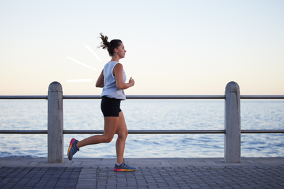 Woman learning how to start running along a beachfront