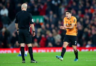 Pedro Neto (right) appeals to referee Anthony Taylor as VAR disallows his goal for Wolves