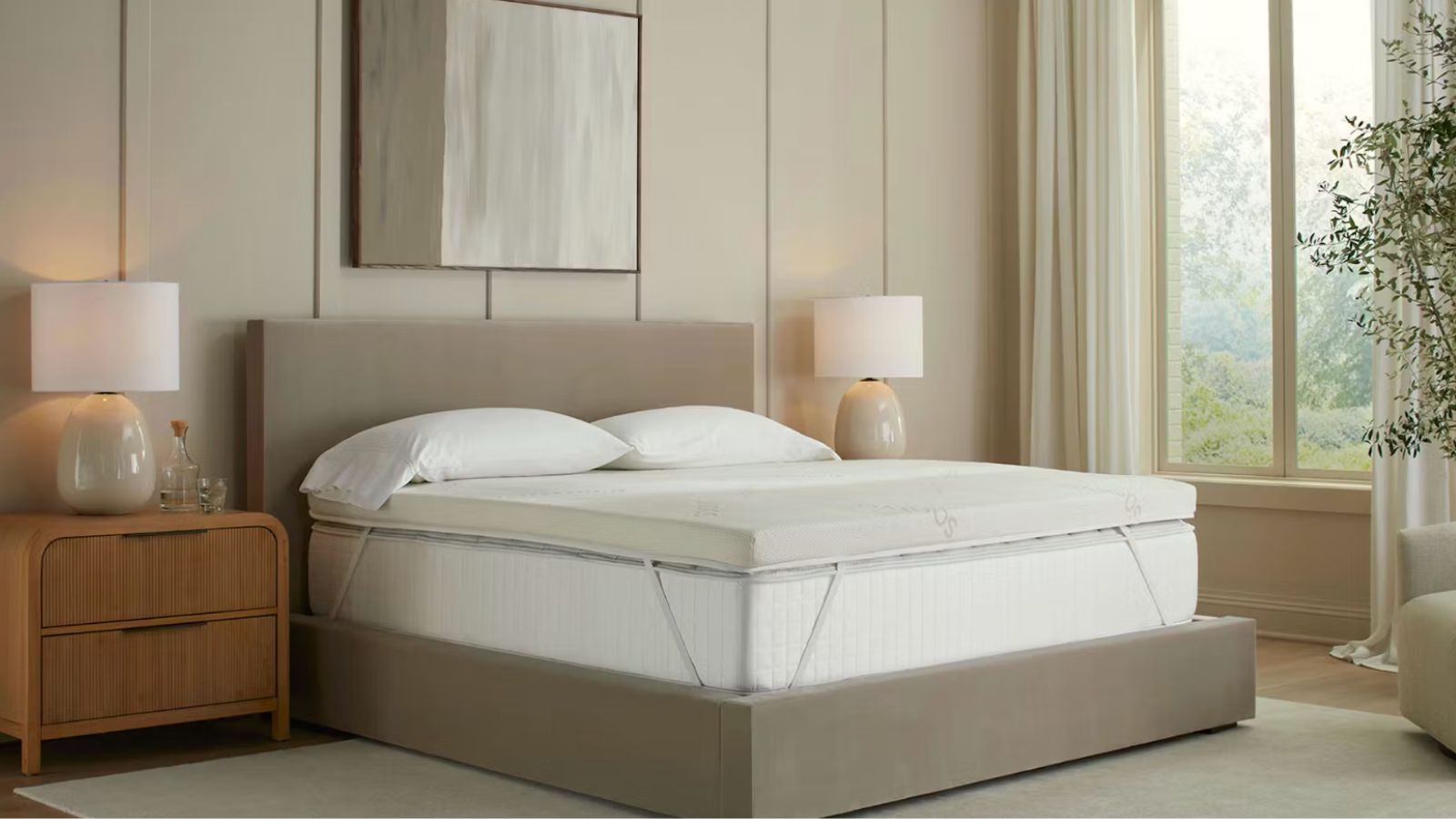 Neutral bedroom with beige velvet bed frame, exposed mattress, mattress topper and pillows