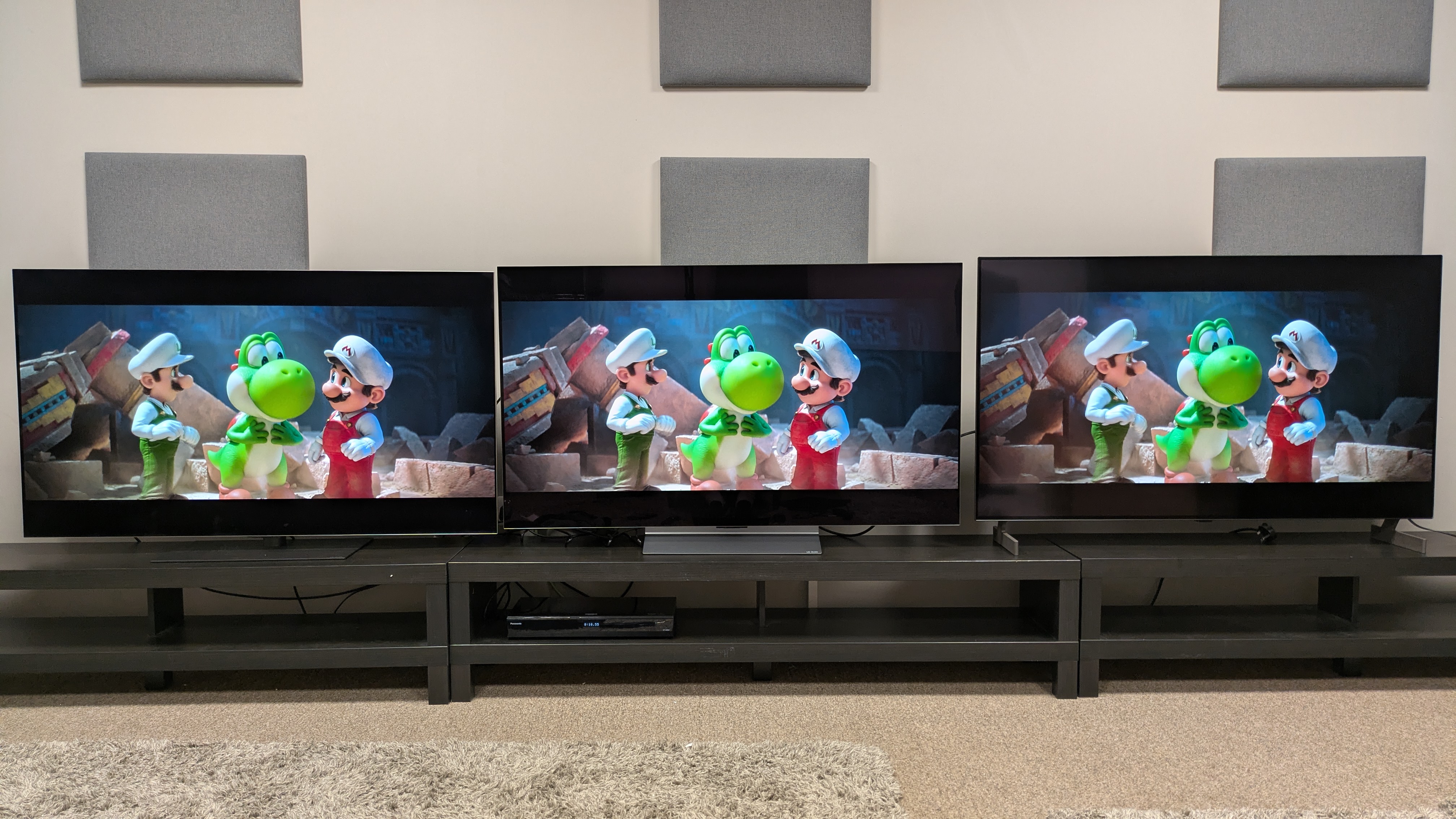 LG G6 (left) vs LG C6 (middle) vs LG B6E (right) showing mario and Luigi standing either side of Yoshi from The super Mario Galaxy Movie. Accurate colors on all three TVs, with little difference
