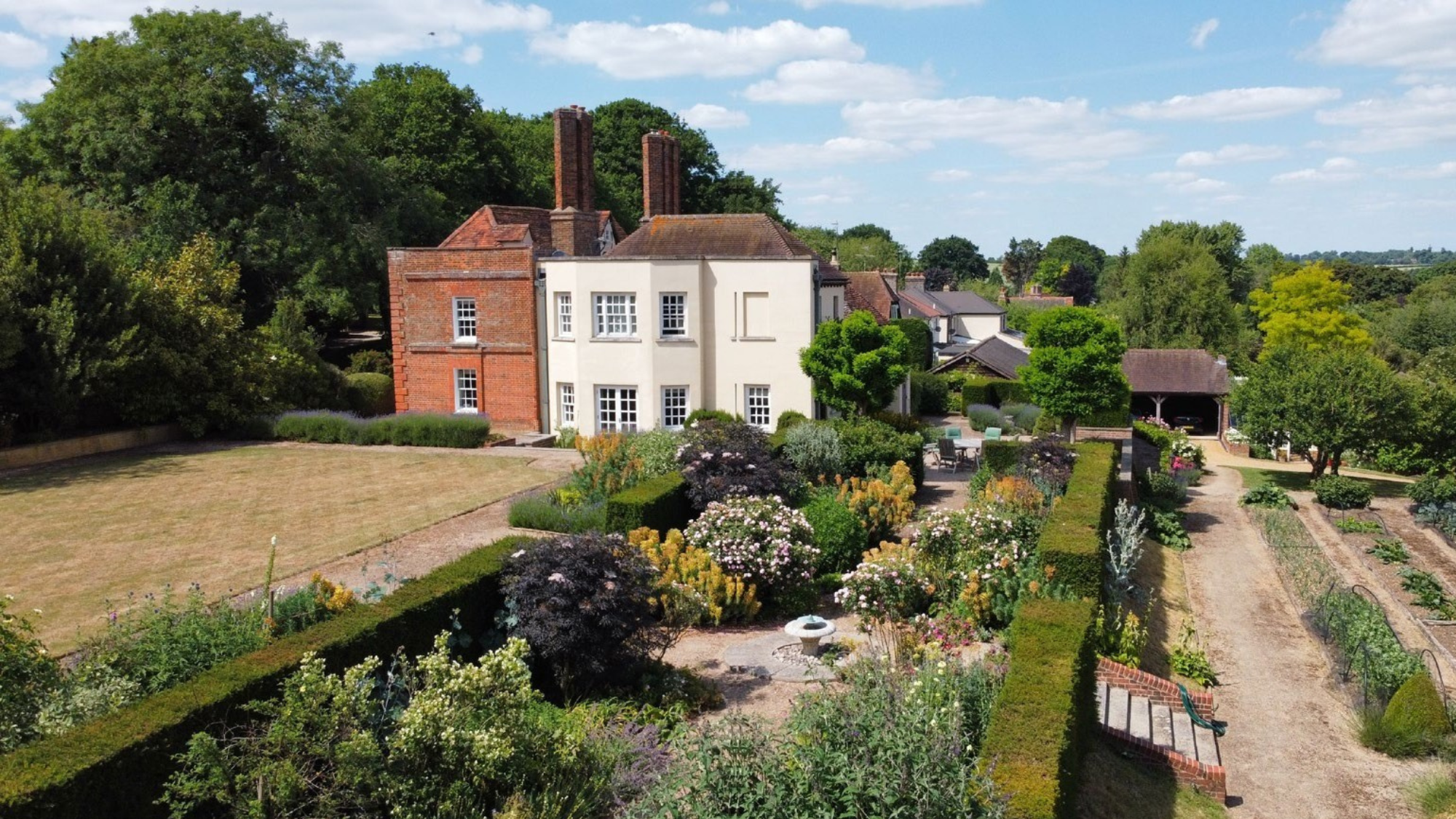 Queen Anne-fronted house with landscaped grounds and a kitchen garden in Hertfordshire.