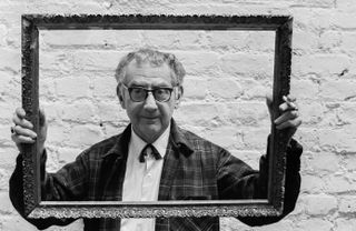 Artist and photographer Man Ray looks through a picture frame, October 24th 1963.