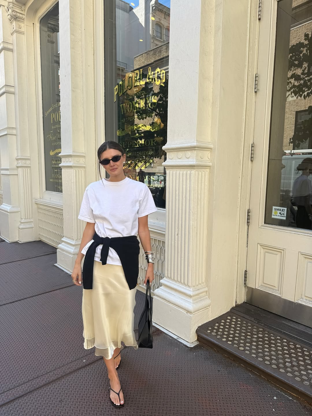 Coco in yellow slip skirt and black flip flops