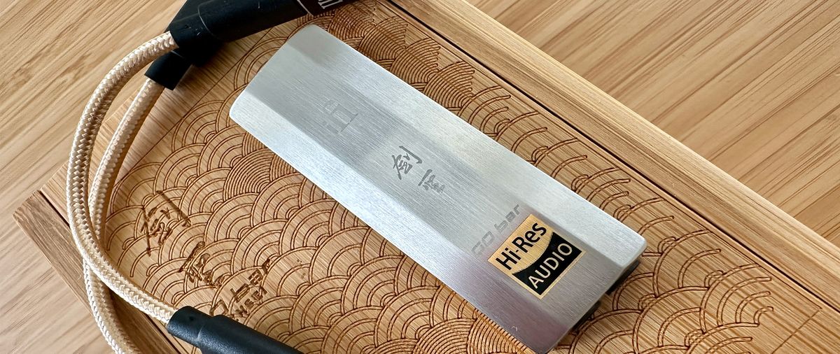 The iFi GO Bar Kensei on top of a wooden box