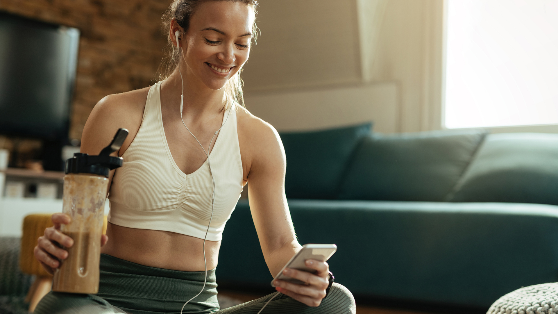 woman drinking a meal replacement shake after her workout