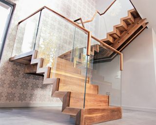 A Walnut stair railing idea with glass and floating stairs by David Smith St. Ives