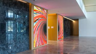 A vibrant and colorful digital display highlights the entryway in a Dallas property.