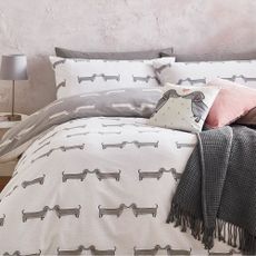 bedroom with dog print bedding and grey lamp