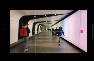 iPhone viewfinder screen showing a tunnel with people walking