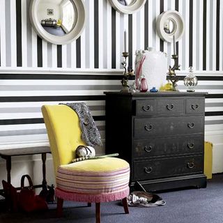 hallway with striped wallpaper and drawers
