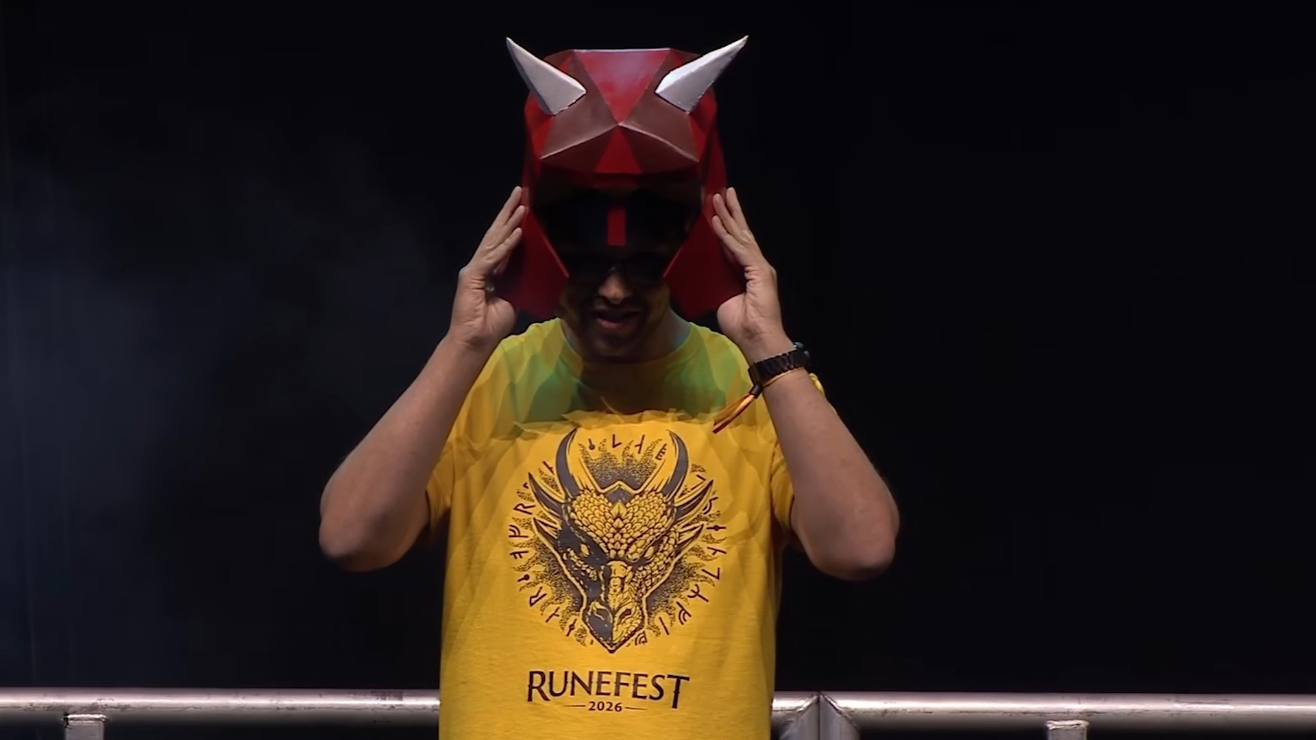 Old School RuneScape dev Mod Kieren in yellow shirt on RuneFest stage