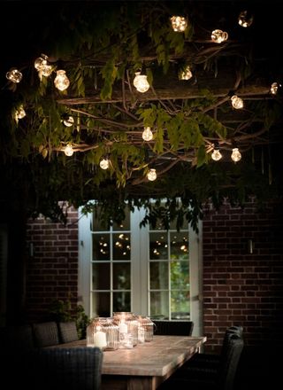 festoon lights over an outdoor dining area