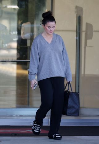 Selena Gomez wears the Reformation Jadey sweater while leaving Rare Beauty's offices