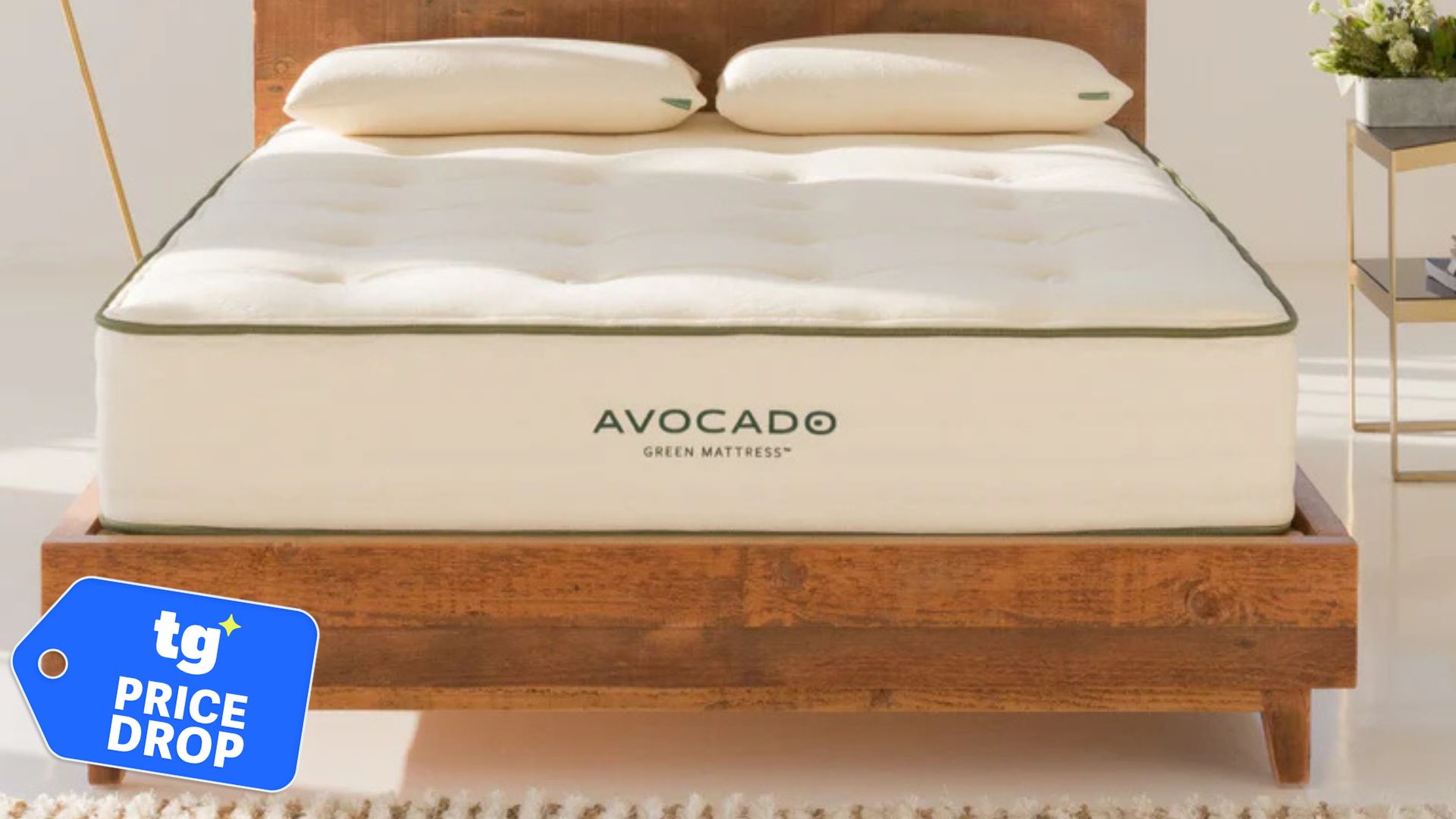 The Avocado Green Mattress in a brightly-lit bedroom. In the bottom left foreground, there is a Tom's Guide Price Drop deals graphic