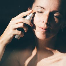 Woman applying a science-led skincare product