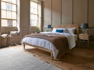 a brown bedroom with wall panelling