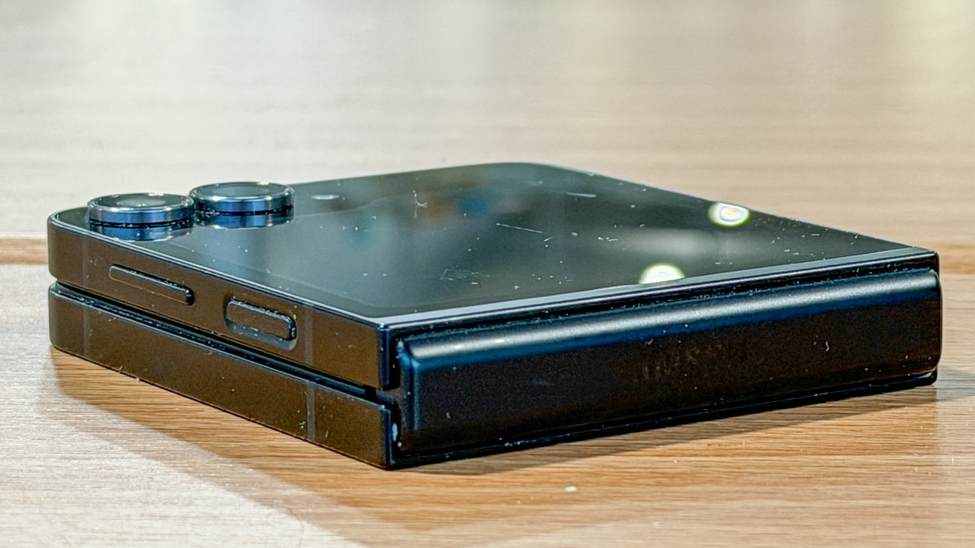 Samsung Galaxy Z Flip 7 FE in piano black color showing content on the cover display and the main screen